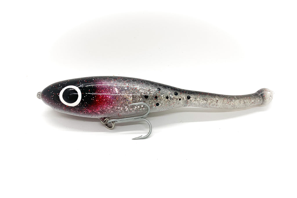 Corky devil with a black head, red gills, clear body and black trout spots.